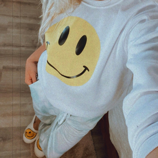 SMILE!...This is the cutest smiley face sweater EVER! Crew neck sweatshirt featuring bright smiley face in the center. Yellow smiley face with black outlines. Long sleeves. The cutest sweater that you can easily throw and for an adorable and easy breezy casual look.